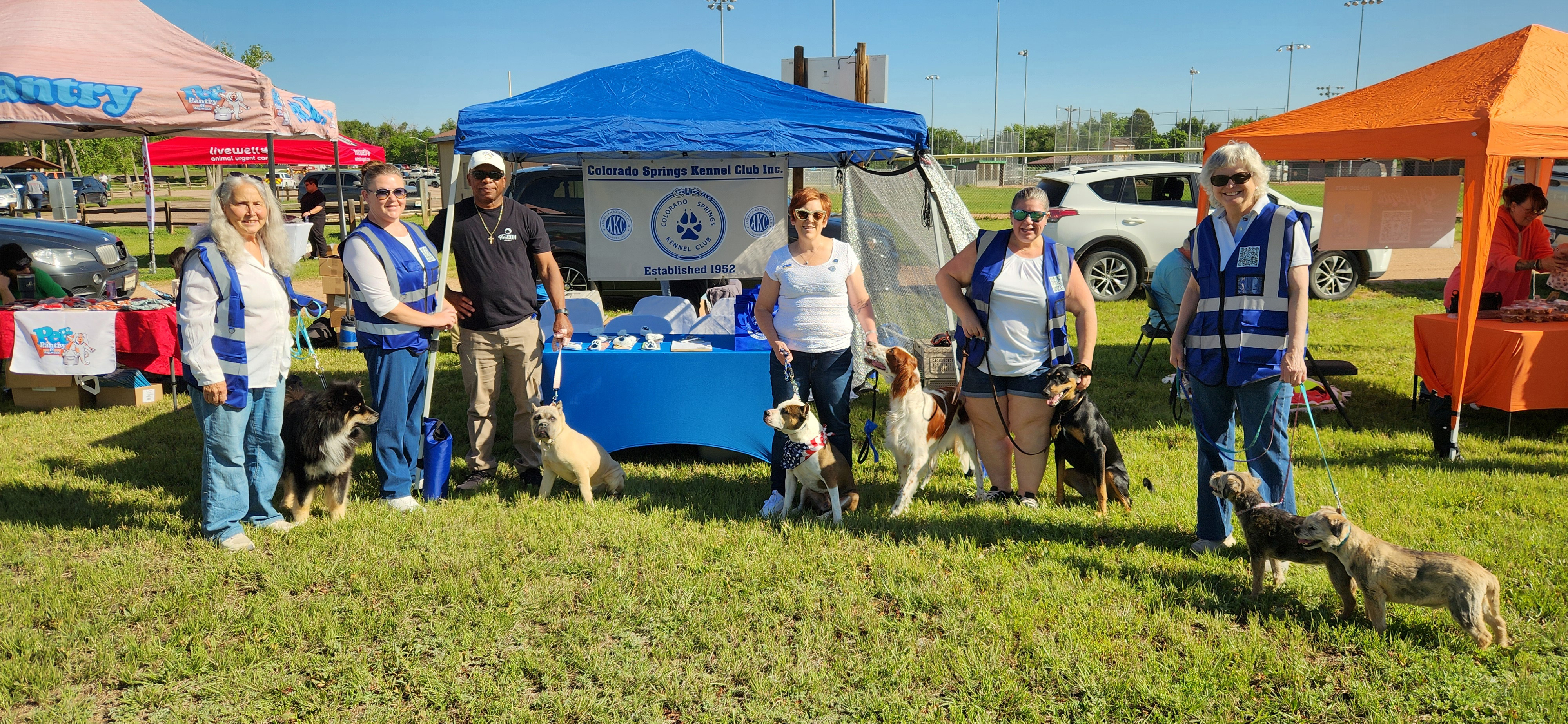 Club members and their dogs at the club tent at Bark in the Park